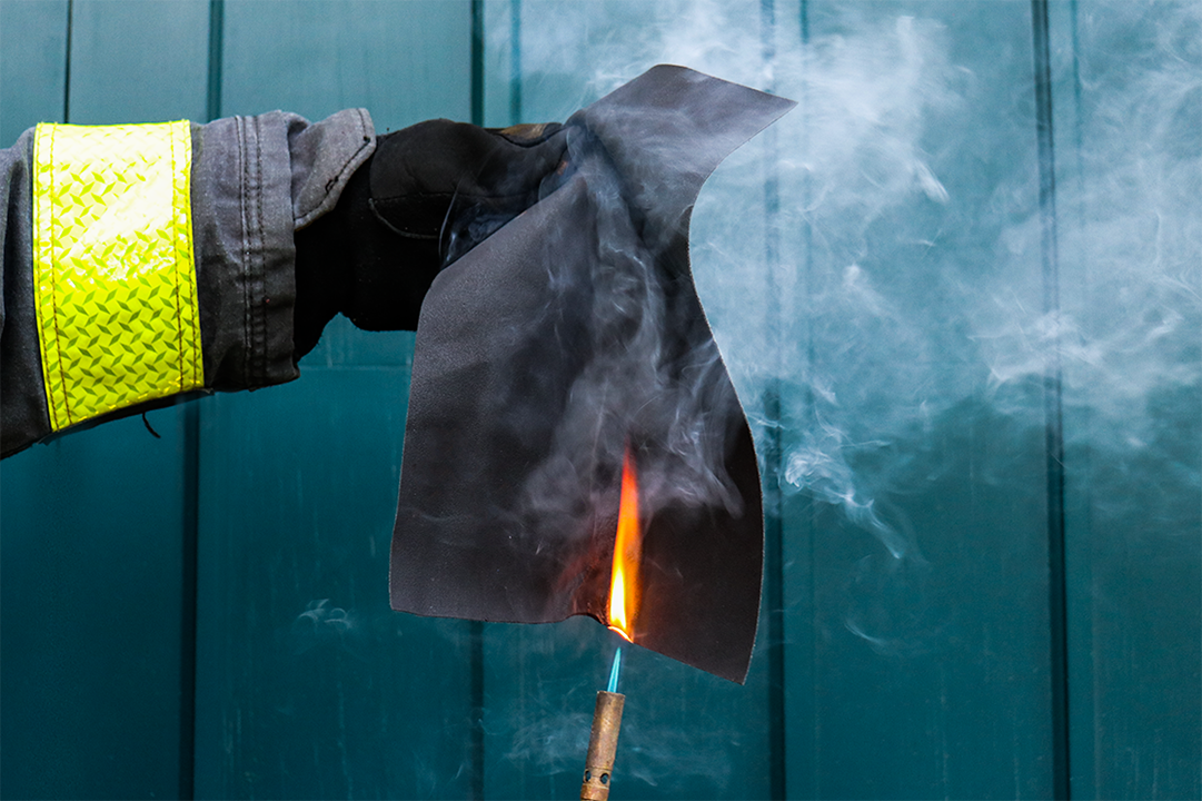 Glove holding material being lit aflame