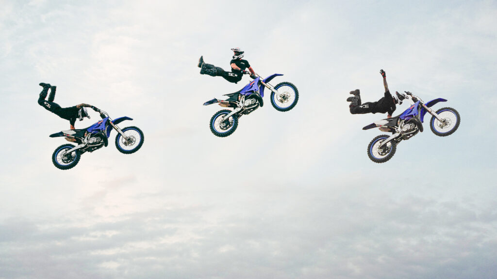A freestyle motocross rider performing three different mid-air bike tricks against a clear sky background.